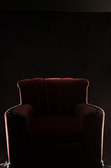 silhouette of red arm chair on black background