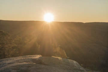 Young man in front of the sun.