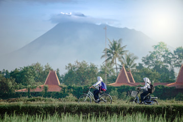Yogyakarta Indonesia June 28, 2020 : Students on the way go to school in Sleman village, with...