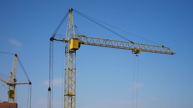 A crane lifts a load at the construction site