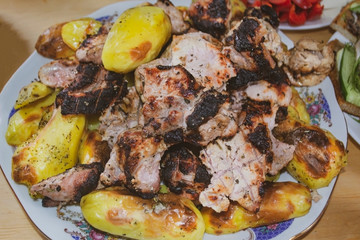 barbecue with baked potatoes on the table