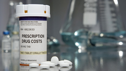 Prescription drug costs bottle in medical lab