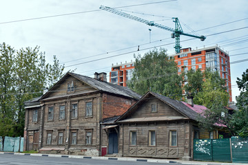 construction on the background of wooden houses. Nizhny Novgorod. Russia