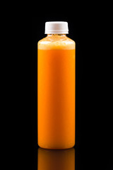 yellow-orange smoothie in a bottle, take concept on black background