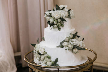 white wedding cake decorated with flowers