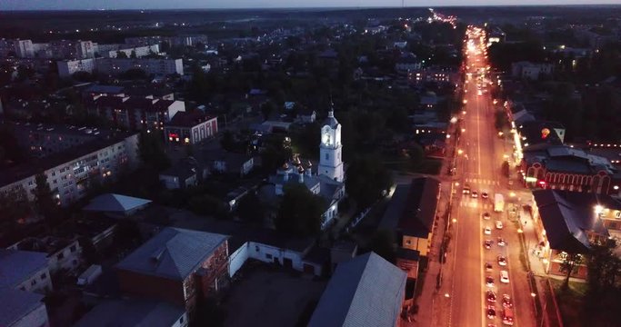 Night aerial view of Russian town of Pokrov with Cathedral of Intercession of Holy Virgin and busy M7 highway 