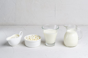 Homemade fermented beverage in a glass of kefir, cottage cheese, sour cream on a white background