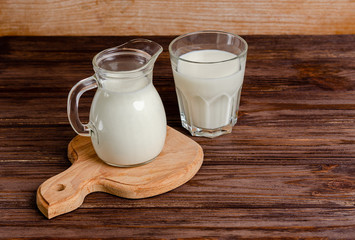 Homemade fermented beverage in a glass of kefir on a wooden background.