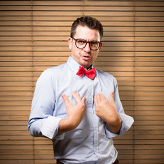 Man wearing a red bow tie. Looking surprised.