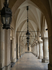 Fototapeta premium Empty arcades of Sukiennice on empty Krakow's Main Market Square during covid-19 coronavirus pandemic.