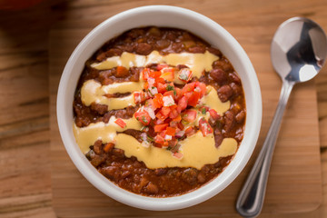 Vegetable Chili with pico de gallo and spoon on the side