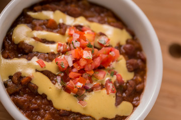 Vegetable Chili with pico de gallo and spoon on the side