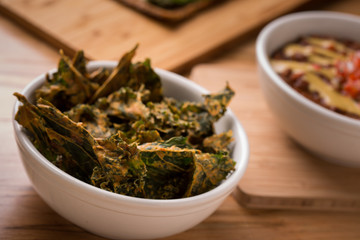 Kale Chips with Chili on a wood rustic table