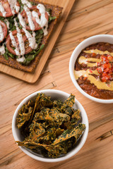 Vegan cuisine with chili, raw pizza, and kale chips