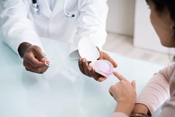 Gynecologist Consulting Woman On Diaphragm Contraception Method