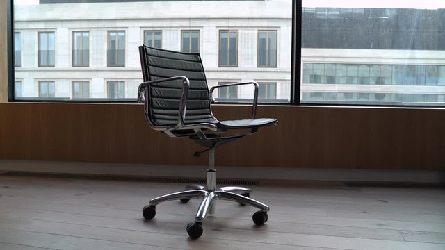 modern black office chair loop rotate on skyscraper background