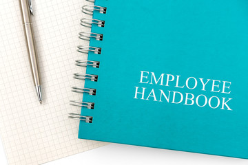 Employee Handbook or manual with a pen and paper on a white table in an office - personnel...