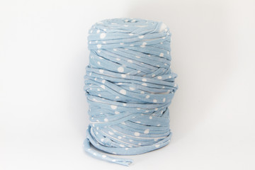 blue fabric with moles for knitting on white background. Trapillo