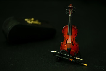  Violin miniature against black background, the show is going to start, music and art