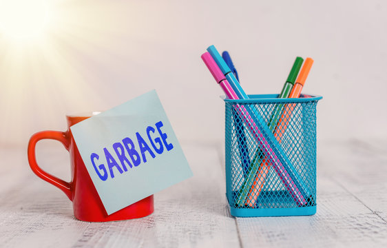 Word Writing Text Garbage. Business Photo Showcasing Waste Material Or Unwanted Things That You Throw Away Rubbish Coffee Cup Mug Hot Drinks Blank Sticky Note Pens Metal Holder Wooden Table