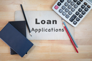 Loan Applications sign flat lay background with home office  supplies financial industry 