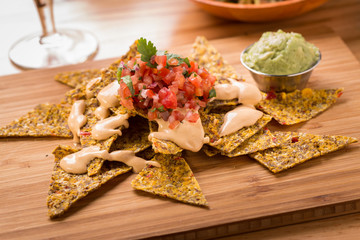 Raw Nachos with pico de gallo vegan cheese and guacamole