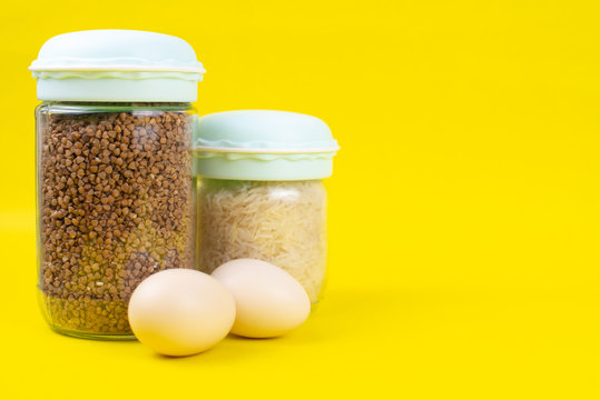Food stock for quarantine isolation period on yellow background. Rice, egg, buckwheat. Food delivery, Donation. Copyspace