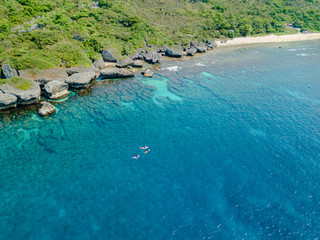 Aerial view of ocean shore with kayaking boats, Little Liuqiu Island, Lambai Island, Pingtung, Taiwan