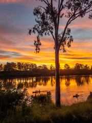 Beautiful River Sunset with Canoes in Portrait Mode