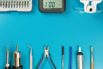 Tools for repairing phones, tablets and electronic equipment with copy space on a blue background....