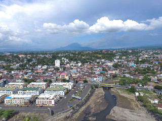 Aerial skyscrapers marina in the sunny day with front line of office, home, urban city Manado Indonesia