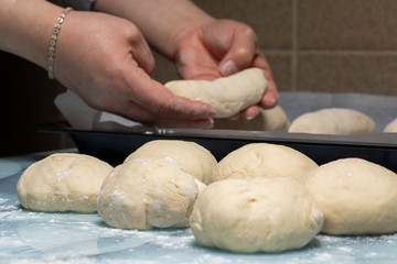 woman makes dough for making bread at home