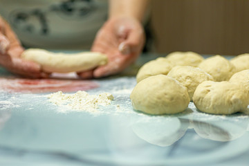 woman makes dough for making bread at home