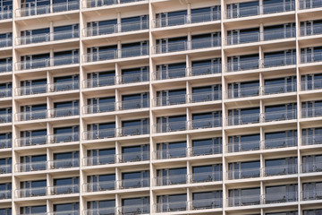 A closeup detail shot of patterns created from balconies on urban residential buildings.