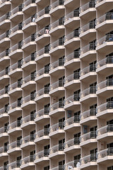 A closeup detail shot of patterns created from balconies on urban residential buildings.