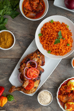 Grilled chicken with red onions. African food meal. Nigerian national dish. Fresh and healthy with tomatoes and red onions. Fried food. Fresh salad with peppers Cuisine