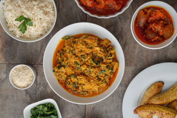 African dishes healthy lifestyle dish with plantain rice and Jollof Rice. Jolof Meal. Egg and plantain. Jelly fish dish with Healthy salad.