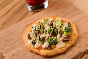Raw Foods Pizza with broccoli, mushrooms, and cashew cheese