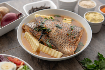 Grilled fish curry with plantain and salad. African national dish. Nigerian fish curry. Healthy lifestyle meal. Vegetarian food