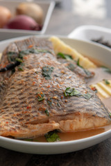 Grilled fish curry with plantain and salad. African national dish. Nigerian fish curry. Healthy lifestyle meal. Vegetarian food