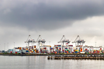 View of the cranes and shipping containers at Port Phillips, Princess pier, Melbourne, Australia.