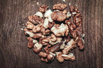 pile of cleaned walnut kernels at the wooden table