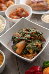 African national food dish grilled meat and chicken dish wings home-made Cuisine with plantain with jollof rice. Nigerian Jolofrice. Grilled African fish dish and meal with chilli banana and plantain.