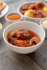 African national food dish grilled meat and chicken dish wings home-made Cuisine with plantain with jollof rice. Nigerian Jolofrice. Grilled African fish dish and meal with chilli banana and plantain.