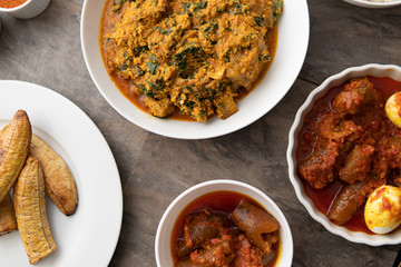 African national food dish grilled meat and chicken dish wings home-made Cuisine with plantain with jollof rice. Nigerian Jolofrice. Grilled African fish dish and meal with chilli banana and plantain.