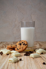 milk and cookies on wooden table
