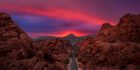 Valley of Fire State Park, Nevada, United States. Aerial panoramic view on the scenic road in the desert during a cloudy twilight. Dramatic Sky Overlay.