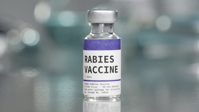 Rabies vaccine vial in medical lab slowly rotating.