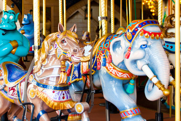 Fototapeta na wymiar Beautiful horses about an elephant, children's carousel, amusement Park
