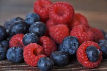 ripe raspberries and blueberries closeup